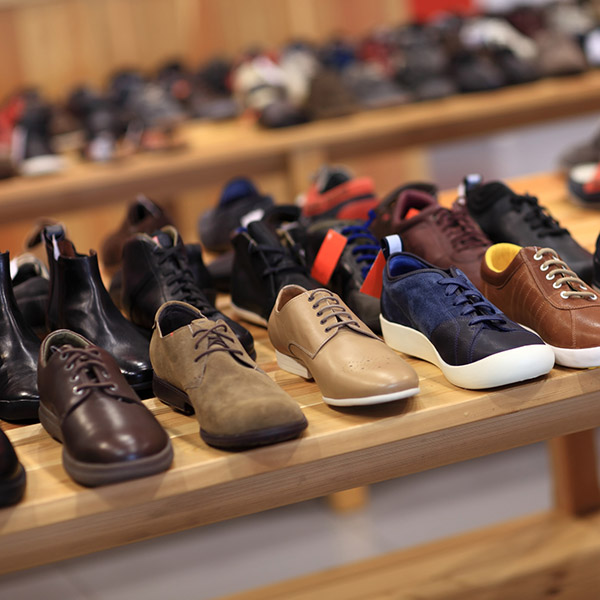 Shoes on the wooden shelf in the store